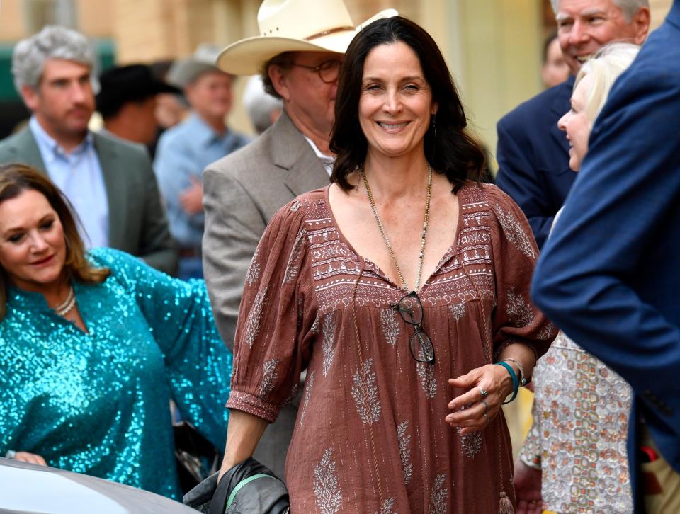 Actress Carrie-Anne Moss walks along Cypress Street with the rest of the crowd strolling from The Grace Museum to the Paramount Theatre for Wednesday’s premiere of “Chocolate Lizards."