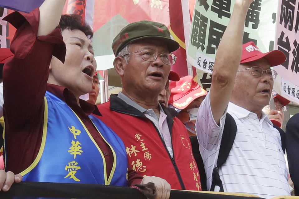 Chairman of Taiwan People's Communist Party Lin Te-wang, center, attends a protest outside of the Taipei International Convention Center during the Taiwan-U.S. Defense Industry Forum in Taipei, Taiwan on May 3, 2023. Prosecutors in Taiwan have indicted Lin and the party's Vice Chairman Chen Chien-hsin on accusations they colluded with China in an effort to influence next year’s elections for president and members of the legislative assembly. (AP Photo/Chiang Ying-ying)