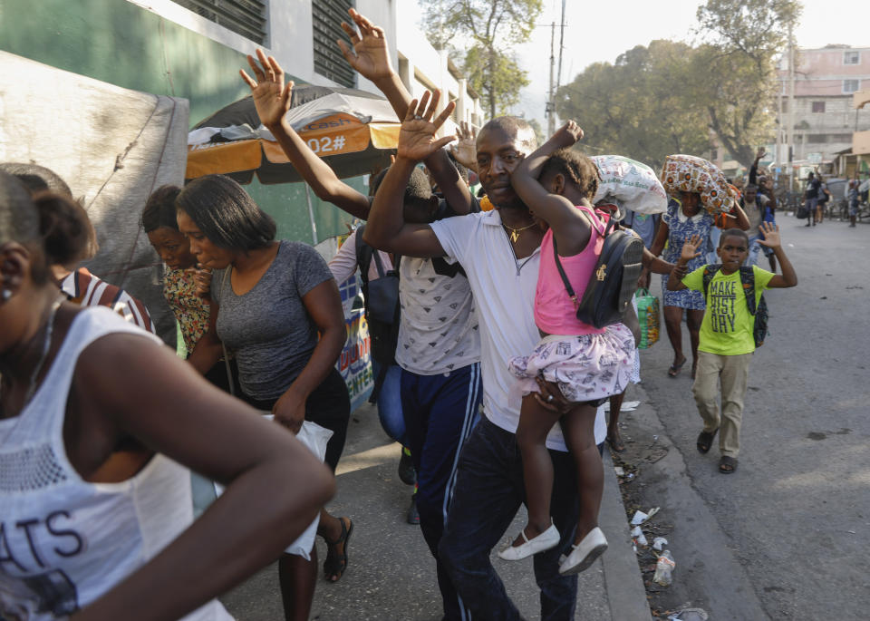 Residents flee their homes during clashes between police and gang member at the Portail neighborhood in Port-au-Prince, Haiti, Thursday, Feb. 29, 2024. (AP Photo/Odelyn Joseph)