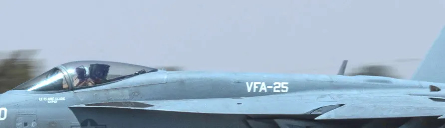 A close-up look at one of the VFA-25 Super Hornets arriving at. The satellite communications antenna found on new-production and upgraded examples is seen at the right. <em>USAF</em>