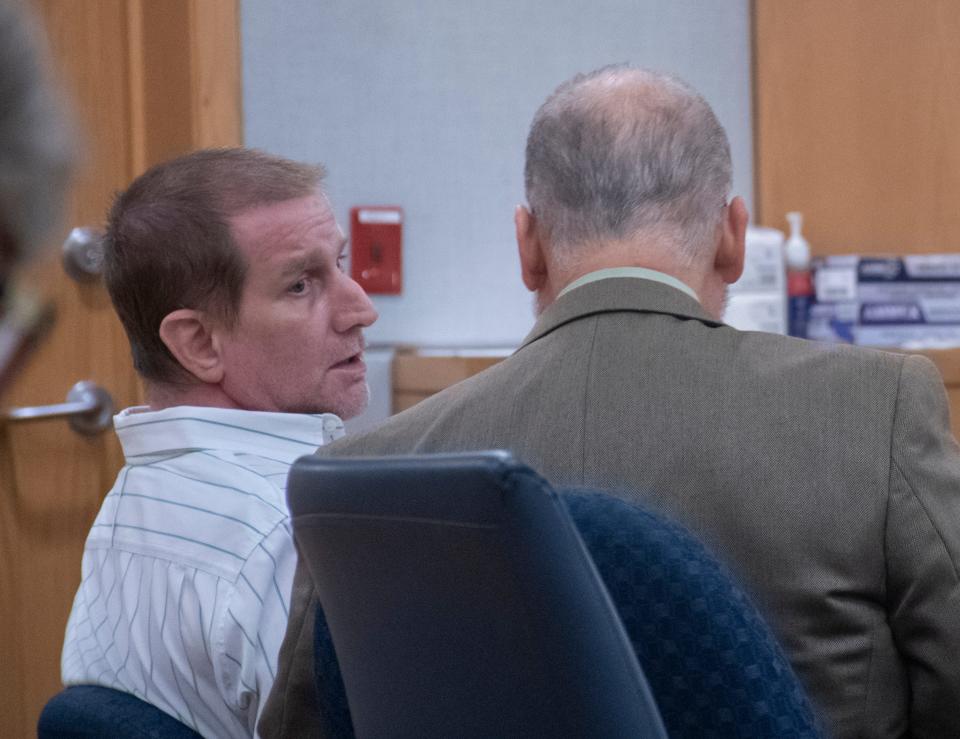 James Blackmon, left, talks with his defense attorney during his trial at the Escambia County Courthouse in Pensacola on Thursday, July 21, 2022.  Blackmon is on trial for alledgedly killing his adult stepson and attempting to kill his stepson's girlfriend.