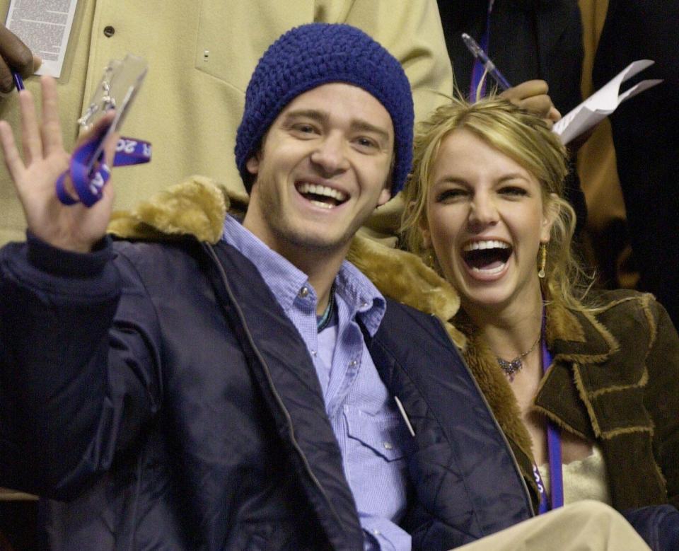 FILE - In this Feb. 10, 2002, file photo, Justin Timberlake and Britney Spears wave to the crowd prior to the start of the 2002 NBA All-Star game in Philadelphia. Timberlake told E! News on Sept. 13, 2016, that he's open to collaborating with Spears. Spears mentioned Timberlake last month in answering a question about who she would like to work with one day. (AP Photo/Chris Gardner, File)