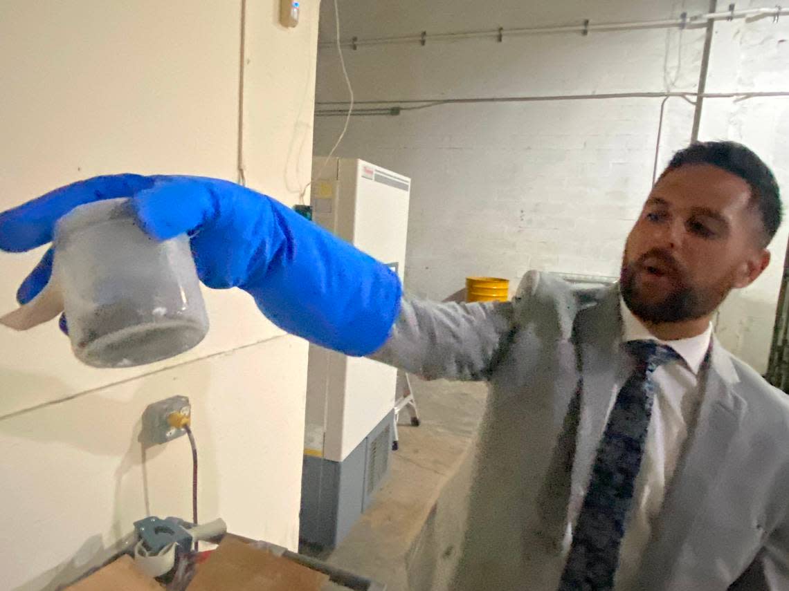 Dylan Boigris, a Coconut Grove trial attorney, holds a sample from the 2010 BP Deepwater Horizon oil spill that is being stored in a South Florida warehouse.