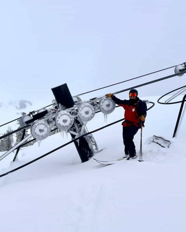 A ski patroller stands above a chairlift tower at Bear Valley Resort (Winter '22/'23)<p>Bear Valley Resort</p>