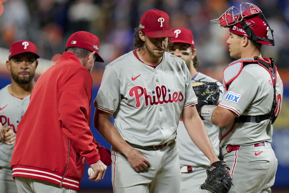 Philadelphia Phillies pitcher Aaron Nola is relieved by manager Rob Thomson during the sixth inning of Game 3 of the National League baseball playoff series against the New York Mets, Tuesday, Oct. 8, 2024, in New York. (AP Photo/Seth Wenig)