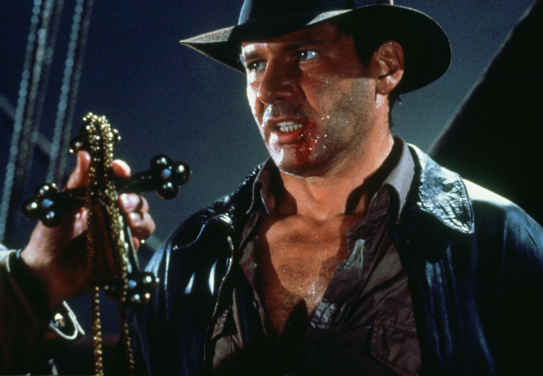 American actor Harrison Ford as the eponymous archaeologist in a scene from the film 'Indiana Jones and the Last Crusade', 1989. Here he traces the Cross of Coronado to a Portuguese vessel.  (Photo by Murray Close/Getty Images)