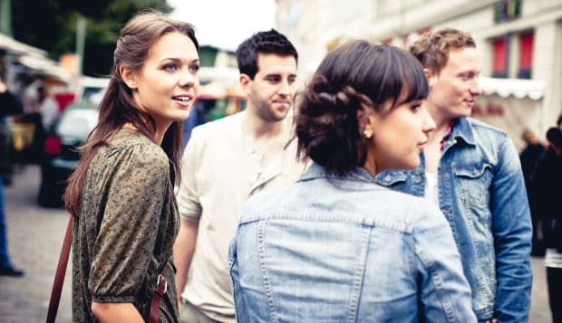 Four young adults in city