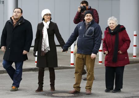 Jason Rezaian (2R), one of the U.S. citizens recently released from detention in Iran, walks to meet media together with his wife Yeganeh Salehi (2L), mother Mary Rezaian (R) and brother Ali Rezaian (L) outside the Emergency Room of the Landstuhl Regional Medical Center (LRMC) in the southwestern town of Landstuhl, Germany, January 20, 2016. REUTERS/Kai Pfaffenbach