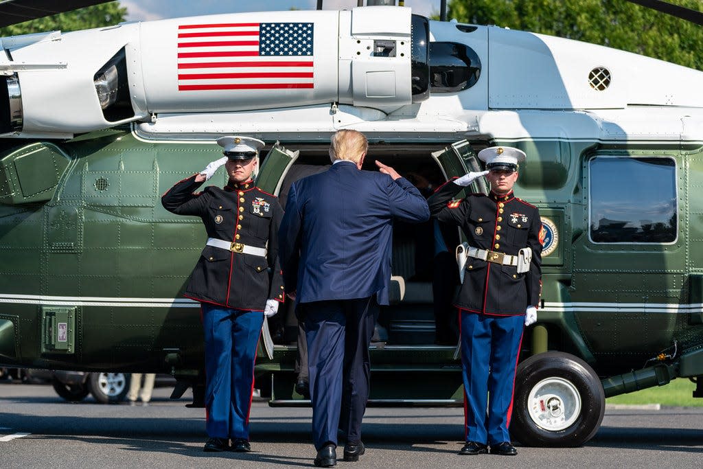 Donald Trump salutes soldiers as he boards Marine One