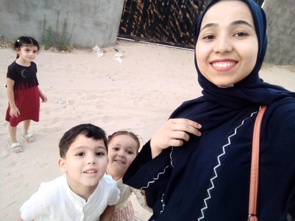 Dima Mohamed Abu Asaker with her nephews who ‘cannot endure the sounds of the bombs’ (Supplied)