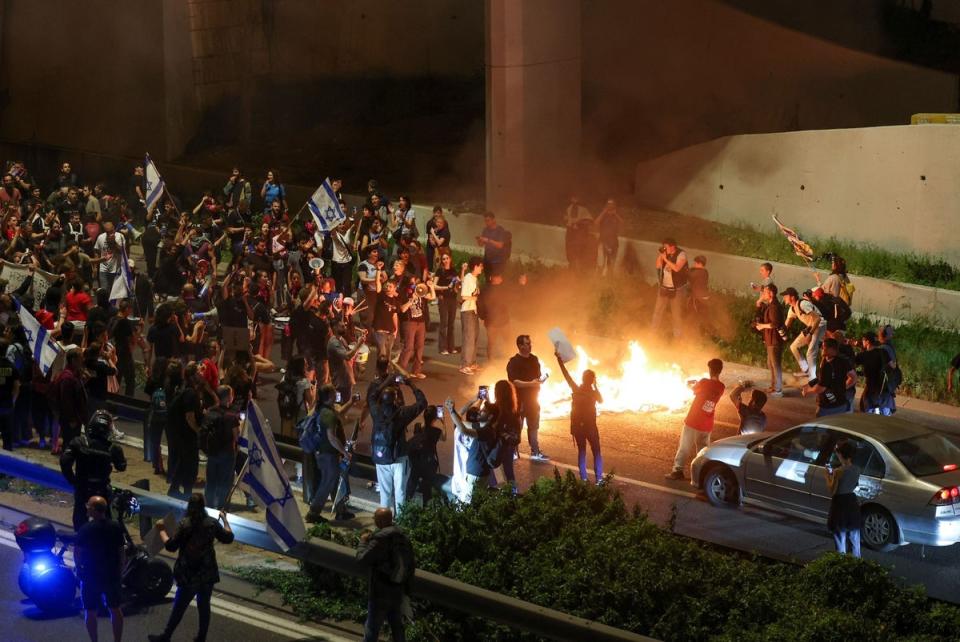 Demonstrators light a fire and block a road during a protest in Jerusalem (AFP via Getty Images)