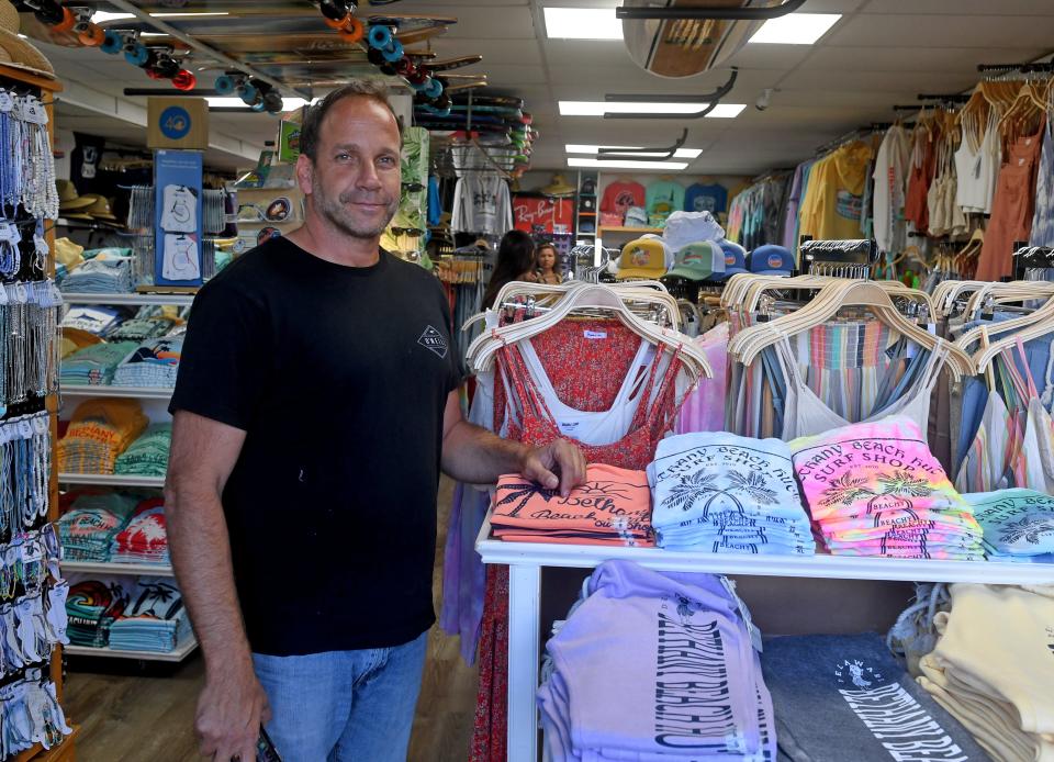 Eric Efergan, owner of Tropicana T-shirt and surf shop, works in his Bethany Beach Hut Surf Shop Thursday, June 17, 2021, in Bethany Beach, Del.