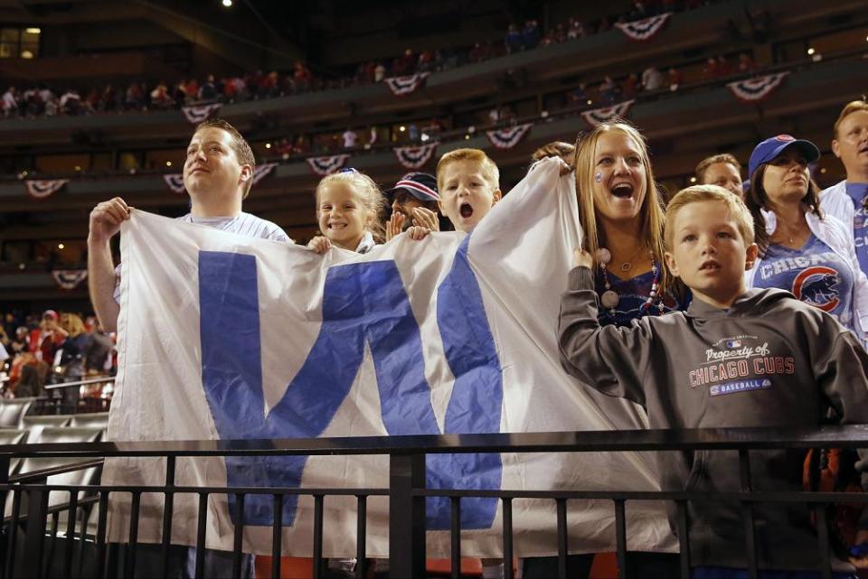 Cubs fans fly the ‘W’ flag during a playoff game in 2016. (AP)