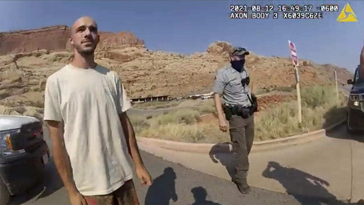 FILE- In this image taken from police body camera video provided by The Moab Police Department, Brian Laundrie talks to a police officer after police pulled over the van he was traveling in with his girlfriend, Gabrielle "Gabby" Petito, near the entrance to Arches National Park in Utah on Aug. 12, 2021. The family of Petito filed a notice of claim Monday, Aug. 8, 2022, of plans to file a wrongful death lawsuit against the tourist town of Moab, Utah, over police officers' handling of an encounter with Petito and her boyfriend weeks she was found dead in Wyoming. (The Moab Police Department via AP, File)