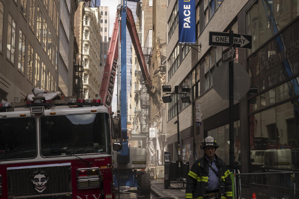 Facade of a partially collapsed parking garage is demolished in the Financial District of New York, Wednesday, April 19, 2023. (AP Photo/Yuki Iwamura)