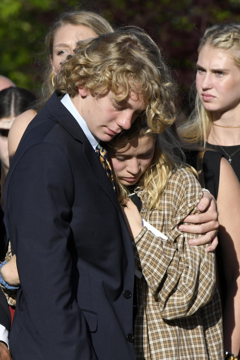 Teddy, brother of Riley Howell, and Lauren Westmoreland, girlfriend of Riley, comfort each other after a memorial service for Riley Howell in Lake Junaluska, N.C., Sunday, May 5, 2019. Family and hundreds of friends and neighbors are remembering Howell, a North Carolina college student credited with saving classmates' lives by rushing a gunman firing inside their lecture hall. (AP Photo/Kathy Kmonicek)