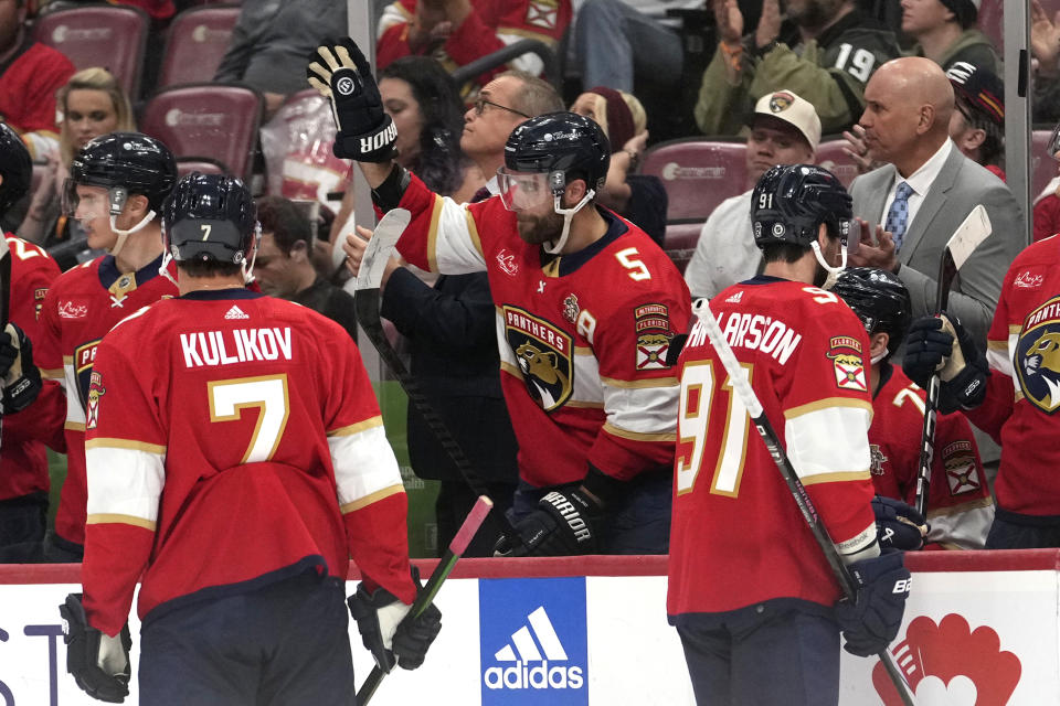 Florida Panthers defenseman Aaron Ekblad (5) acknowledges applause after being recognized for 230 NHL assists during the first period of an NHL hockey game against the Philadelphia Flyers, Thursday, March 7, 2024, in Sunrise, Fla. (AP Photo/Lynne Sladky)