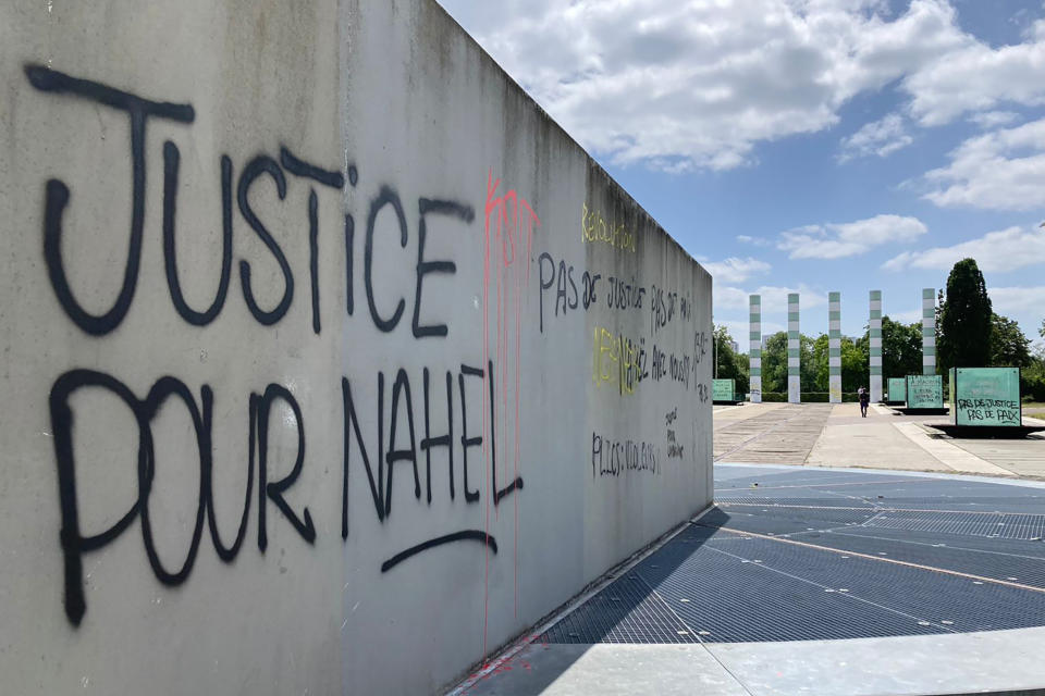 A graffiti reads "Justice for Nahel" on a wall Sunday, July 2, 2023 in Paris suburb Nanterre. A monument commemorating Holocaust victims and members of the French resistance during World War II in Nanterre was still defaced with graffiti Sunday, after it has been vandalized Thursday on the margins of a silent march to pay tribute to Nahel. Vandals painted anti-police slogans including "Police scum from Saint-Soline to Nanterre," "Don't forget or forgive," and "Police, rapists, assassins" (AP Photo/Cara Anna )