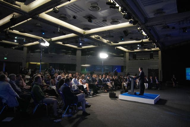 Robert Jenrick addresses audience members during a rally at a conference centre in Westminster