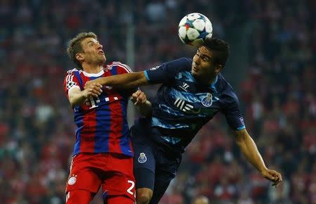 Football - Bayern Munich v Porto - UEFA Champions League Quarter Final Second Leg - Allianz Arena, Munich - Germany - 21/4/15 Bayern Munich's Thomas Muller (L) in action with FC Porto's Casemiro. Reuters / Kai Pfaffenbach