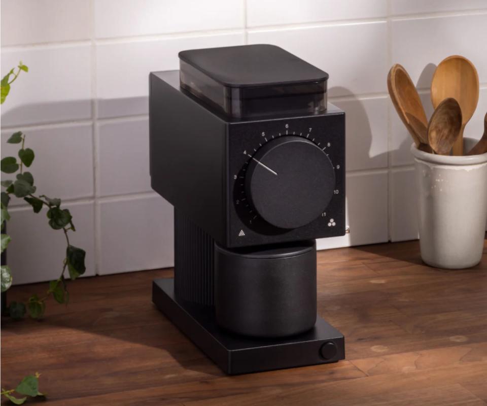 A Fellow Ode Coffee Grinder on a wooden countertop