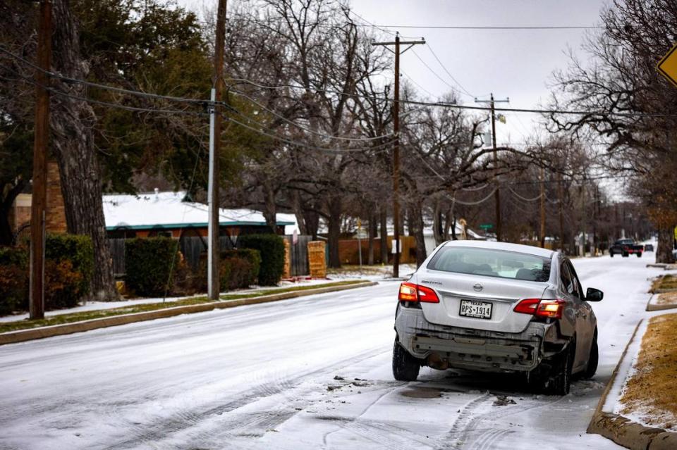 A car is stranded on a neighborhood road during icy weather in Fort Worth on Tuesday, Jan. 31, 2023. Winter storm conditions have extended through Thursday morning as freezing rain continues.