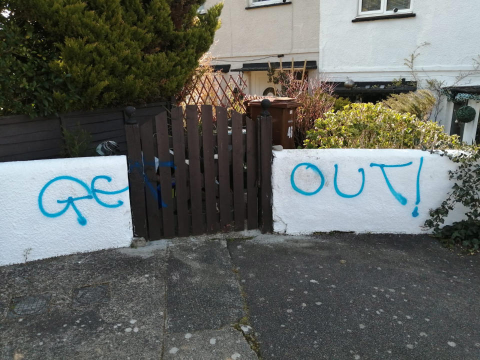 The couple claim they woke up to find 'get out' graffitied on their wall in Chatham, Kent. (Caters)