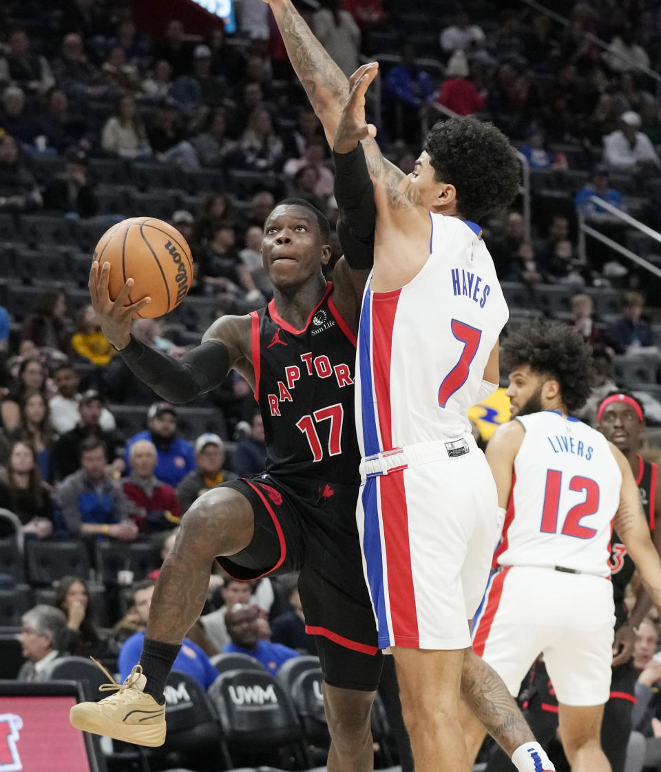 Toronto Raptors guard Dennis Schroder (17) attempts a layup as Detroit Pistons guard Killian Hayes (7) defends during the first half of an NBA basketball game Saturday, Dec. 30, 2023, in Detroit. (AP Photo/Carlos Osorio)