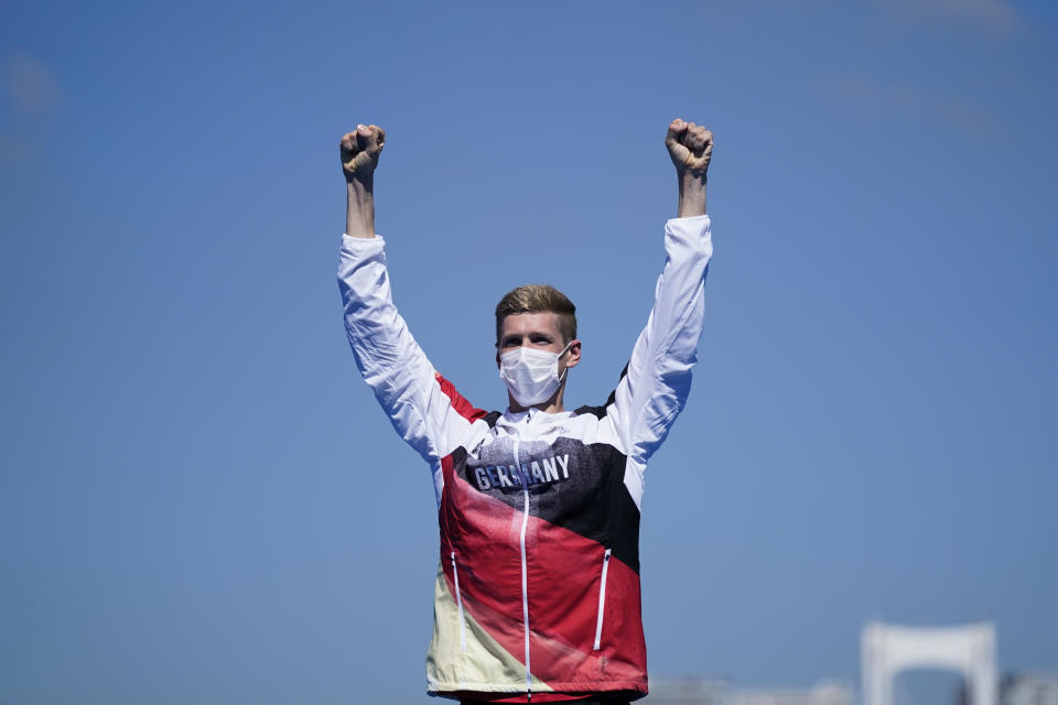 Florian Wellbrock, of Germany, celebrates his gold medal during a victory ceremony for the men's marathon swimming event at the 2020 Summer Olympics, Thursday, Aug. 5, 2021, in Tokyo, Japan. (AP Photo/Jae C. Hong)