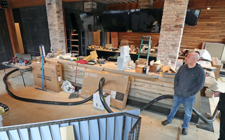 Shawn Monday, owner of Flip Side and One Red Door, takes a look at the progress that is being made in the new Flip Side restaurant location Wednesday in Hudson.