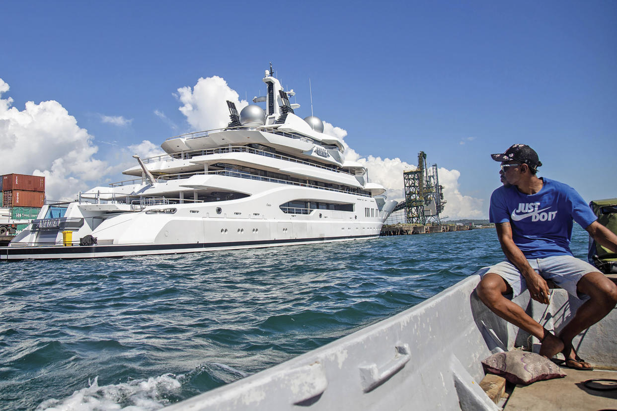 FILE - Boat captain Emosi Dawai looks at the superyacht Amadea where it is docked at the Queens Wharf in Lautoka, Fiji, on April 13, 2022. The superyacht that American authorities say is owned by a Russian oligarch previously sanctioned for alleged money laundering has been seized by law enforcement in Fiji, the U.S. Justice Department announced Thursday, May 5. (Leon Lord/Fiji Sun via AP, File)