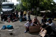 Cubans migrants have a sit-in protest in front of a truck as they wait for the opening of the border between Costa Rica and Nicaragua in Penas Blancas, Costa Rica November 17, 2015. More than a thousand Cuban migrants hoping to make it to the United States were stranded in the border town of Penas Blancas, Costa Rica, on Monday after Nicaragua closed its border on November 15, 2015 stoking diplomatic tensions over a growing wave of migrants making the journey north from the Caribbean island. REUTERS/Oswaldo Rivas
