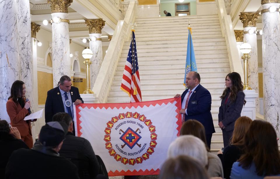 Members of the Rosebud Tribal Government and lawmakers representing the Rosebud area present their tribal flag in the South Dakota Capitol Rotunda on Wednesday, Jan. 10, 2024.