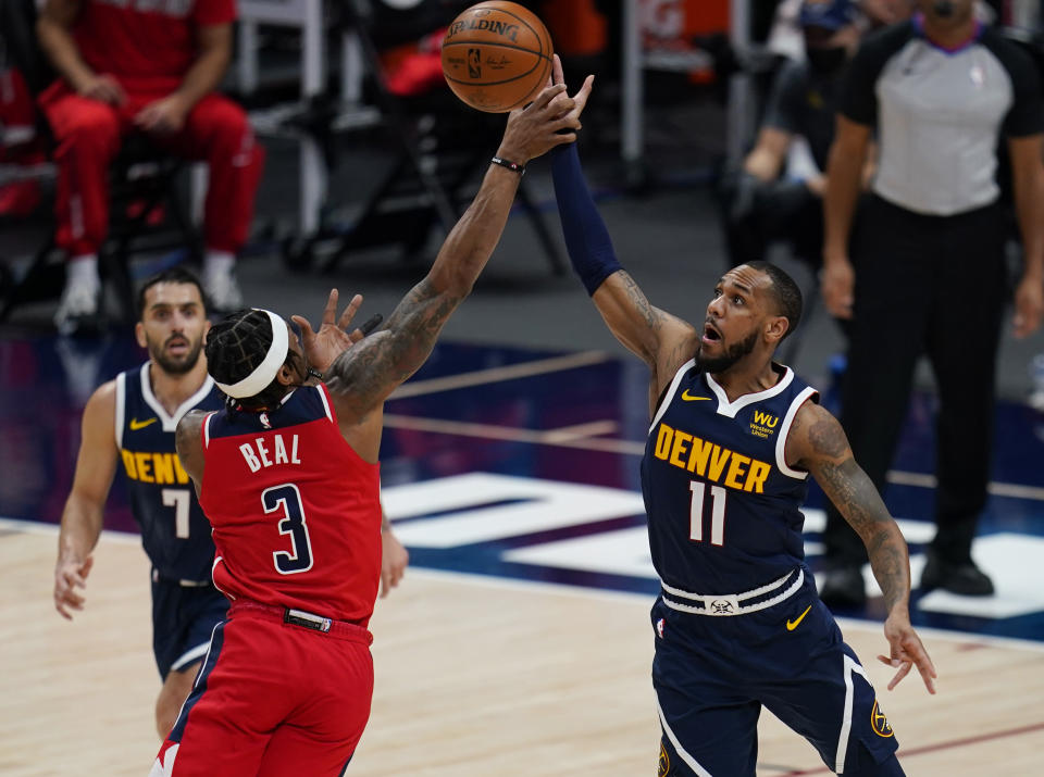 Denver Nuggets guard Monte Morris (11) steals the ball from Washington Wizards guard Bradley Beal (3) during the second quarter of an NBA basketball game Thursday, Feb. 25, 2021, in Denver. (AP Photo/Jack Dempsey)