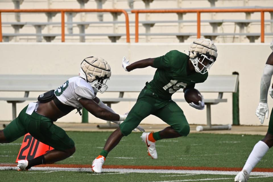 Florida A&M University wide receiver Xavier Smith (19) escapes a tackle from linebacker Johnny Chaney Jr. during team’s first fall scrimmage, Aug. 6, 2022