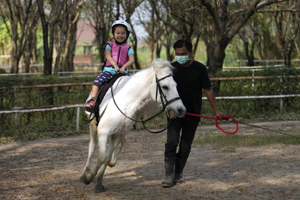 Rylae-Ann Poulin learns to ride a horse in Bangkok, Thailand, Saturday, Jan. 14, 2023.(AP Photo/Sakchai Lalit)