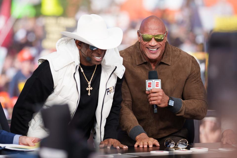 Colorado head coach Deion Sanders and celebrity guest picker Dwayne Johnson share a laugh on the set of College GameDay prior to the game between the Buffaloes and Colorado State at Folsom Field in Boulder, Colo. The Buffaloes improved to 3-0 with a 43-35 double-overtime win.