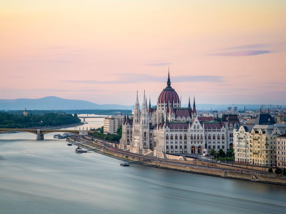 The Hungarian Parliament Building on the Banks of the Danube at dawn.