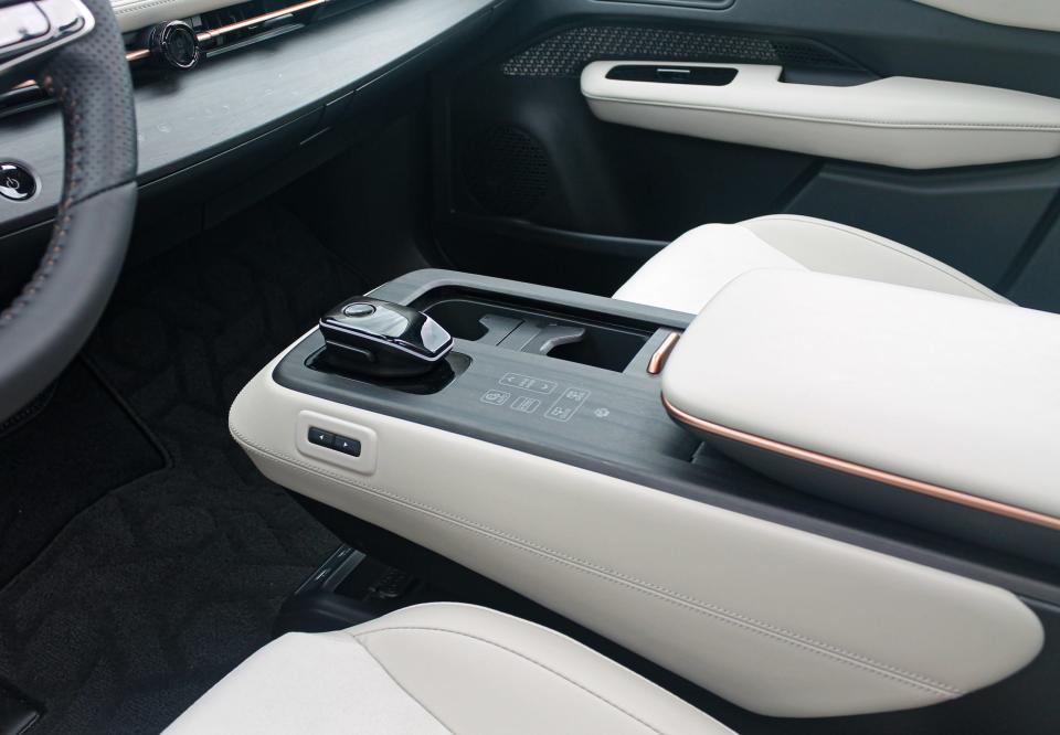 The white and grey center console of the 2023 Nissan Ariya Empower+ SUV.