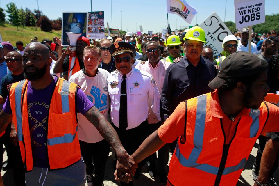 <p>Father Michael Pfleger (2nd left) and Reverend Jesse Jackson (2nd right) walk with Chicago Police Superintendent Eddie Johnson during an anti-violence protest, which shut down the Dan Ryan Expressway in Chicago, Ill., July 7, 2018. (Photo: Jim Young/AFP/Getty Images) </p>