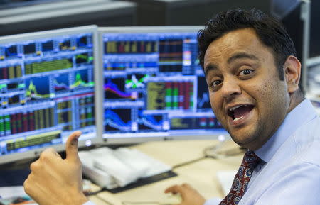 Pranab Patel, a trader at Belgian KBC bank, reacts on the trading floor at the bank headquarters in Brussels, Belgium August 25, 2015. REUTERS/Yves Herman