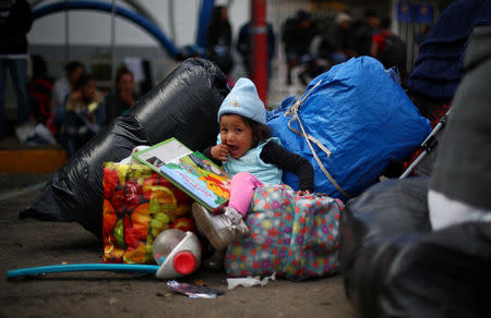 Yareli Dominguez, a three-year-old migrant girl from Honduras, part of a caravan of thousands from Central America trying to reach the United States, waits to board a bus to transport her to a new temporary shelter in Tijuana, Mexico, November 30, 2018. REUTERS/Hannah McKay