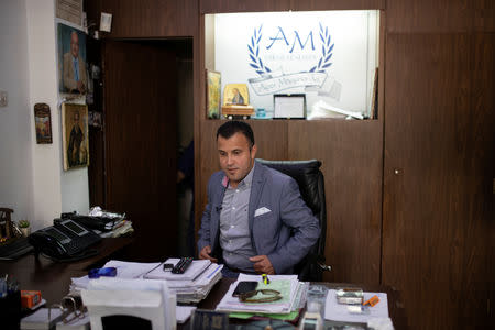 FILE PHOTO: Undertaker and candidate for town councillor at the municipality of Sykies, Konstantinos Baboulas, sits at his office at his family's funeral parlor in Thessaloniki, Greece, May 17, 2019. REUTERS/Alkis Konstantinidis