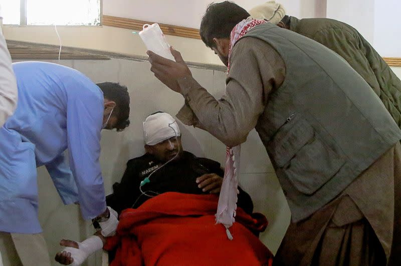 A man receives medical aid in hospital after being wounded in a suicide bomb blast on a police patrol in Quetta