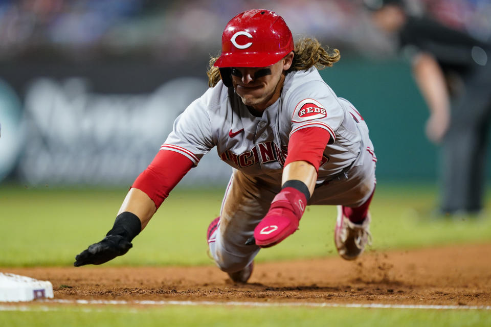 Cincinnati Reds' TJ Friedl dives back to first on a pickoff attempt by Philadelphia Phillies pitcher Aaron Nola during the fifth inning of a baseball game, Thursday, Aug. 25, 2022, in Philadelphia. (AP Photo/Matt Slocum)