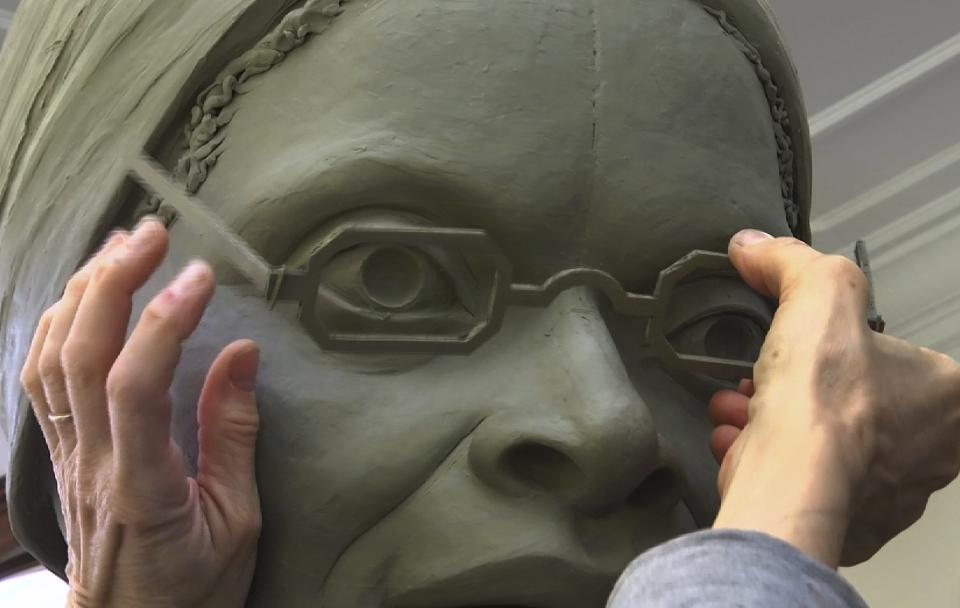 In this Nov. 4, 2019, still image from video, sculptor Meredith Bergmann works on the first women's statue that will be installed in New York's Central Park, in her studio in Ridgefield, Conn. The monument is scheduled to be dedicated Aug. 26, 2020, marking the 100th anniversary of American women winning the right to vote. (AP Photo/Joseph Frederick)