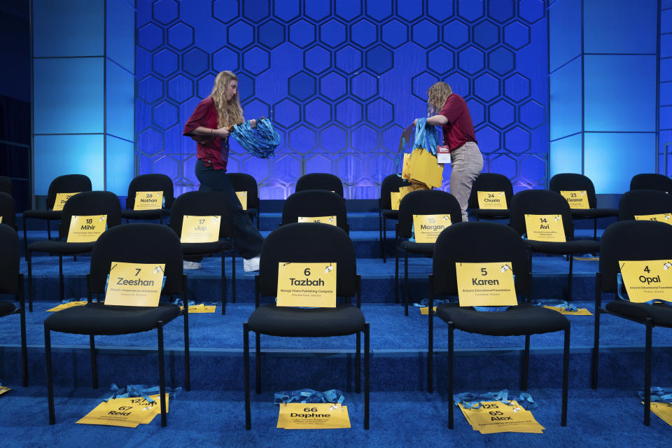 Event staff set the stage for the first round of spellers during the Scripps National Spelling Bee, Tuesday, May 30, 2023, in Oxon Hill, Md. (AP Photo/Nathan Howard)