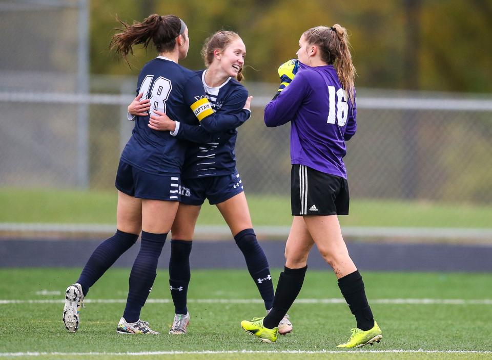 South Oldham's Marley Kahle gets hugged by teammate Clara Spurlock after scoring a goal by Henderson County goalie Chloe Honeycutt, at right, in the first half in Lexington Thursday. Kahle scored two goals within a 57-second span. Oct. 28, 2021