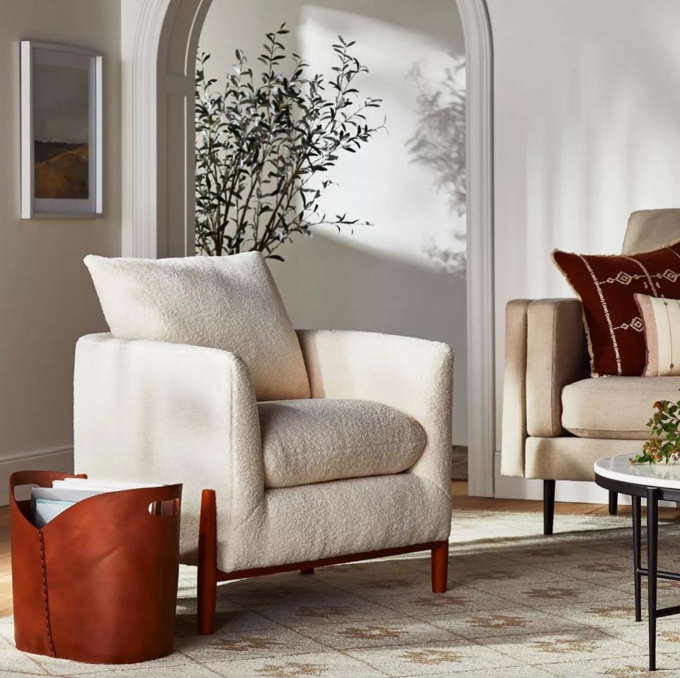 The accent chair with wood legs and beige seat