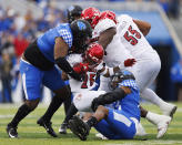 Kentucky linebacker J.J. Weaver (13) tackles Louisville running back Jawhar Jordan (25) during the first half of an NCAA college football game in Lexington, Ky., Saturday, Nov. 26, 2022. (AP Photo/Michael Clubb)